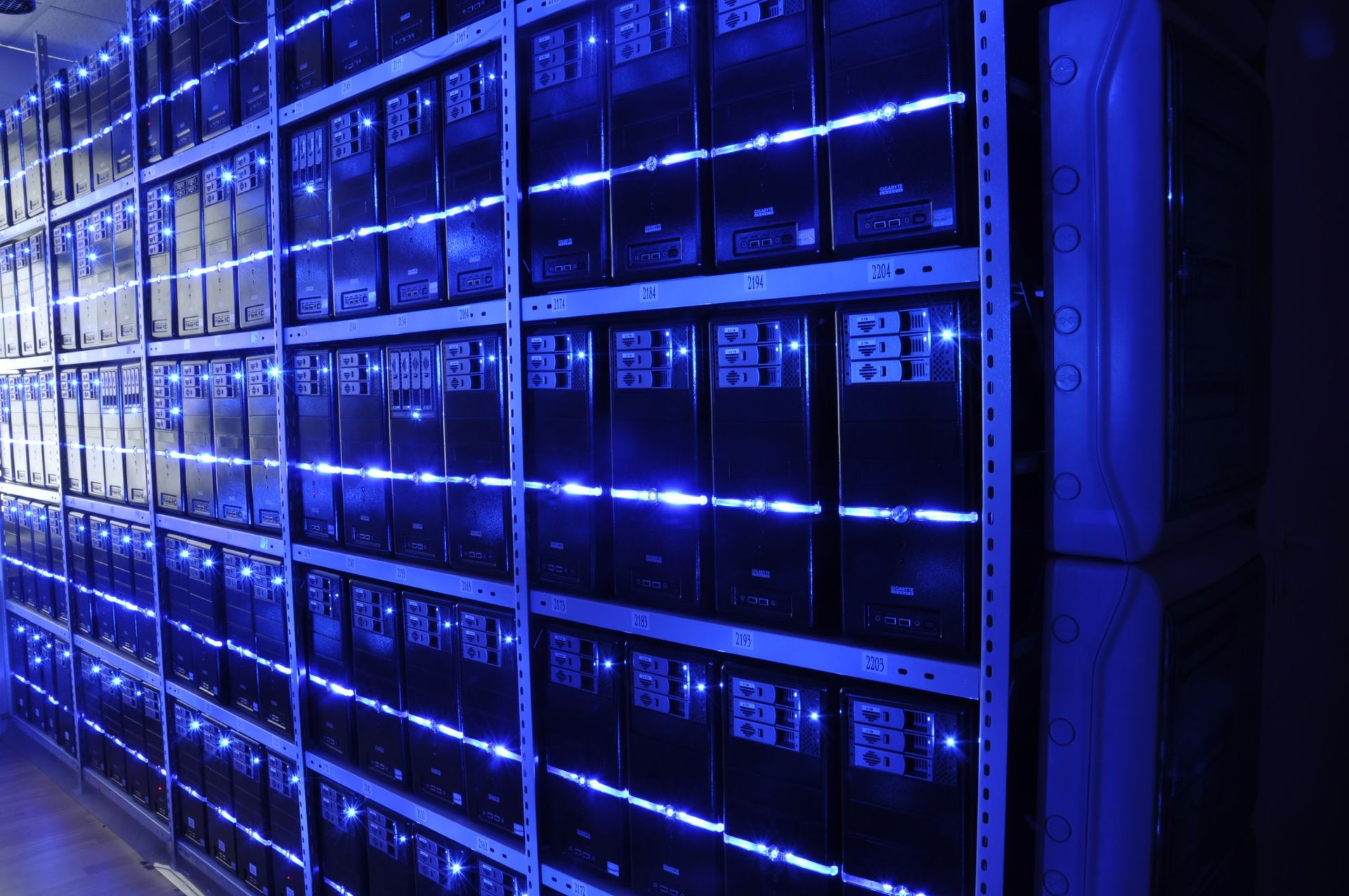 Rows of server racks in a data center, representing the cloud infrastructure behind Claude's compute deals with AWS and Google